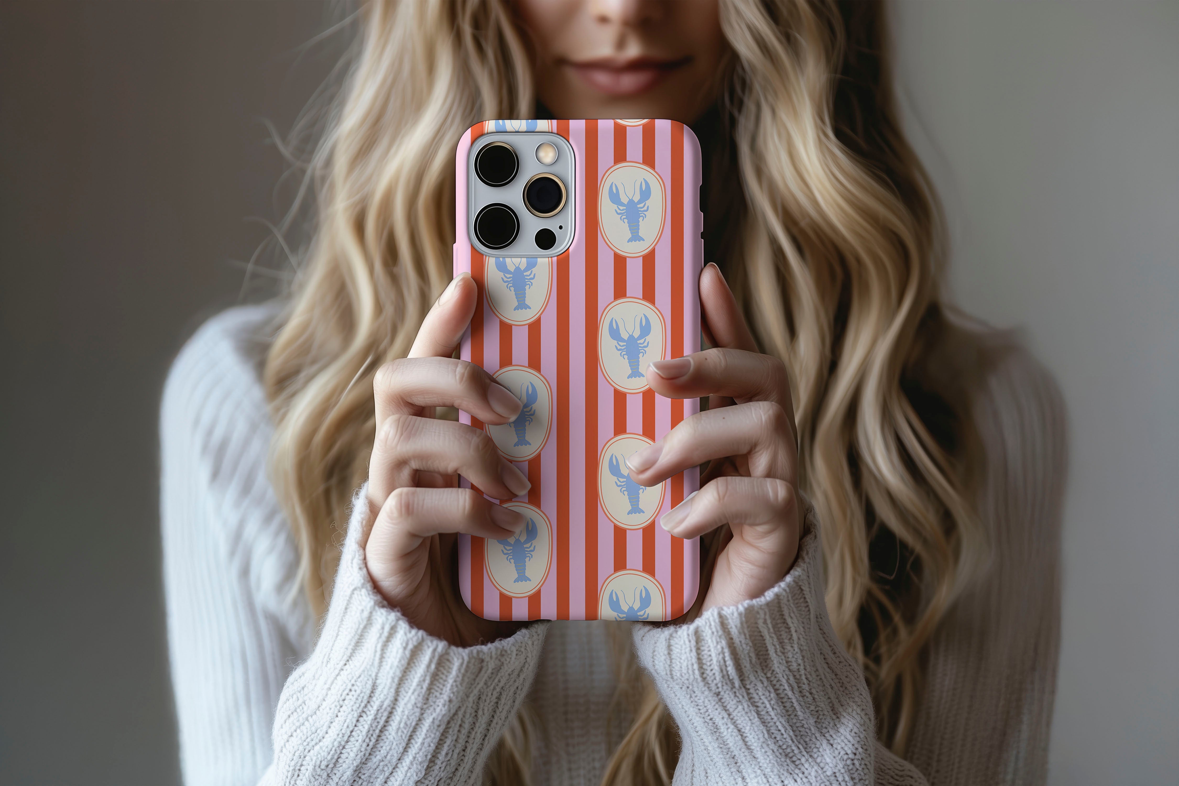 A cute girl holding a phone case featuring our Lobster design