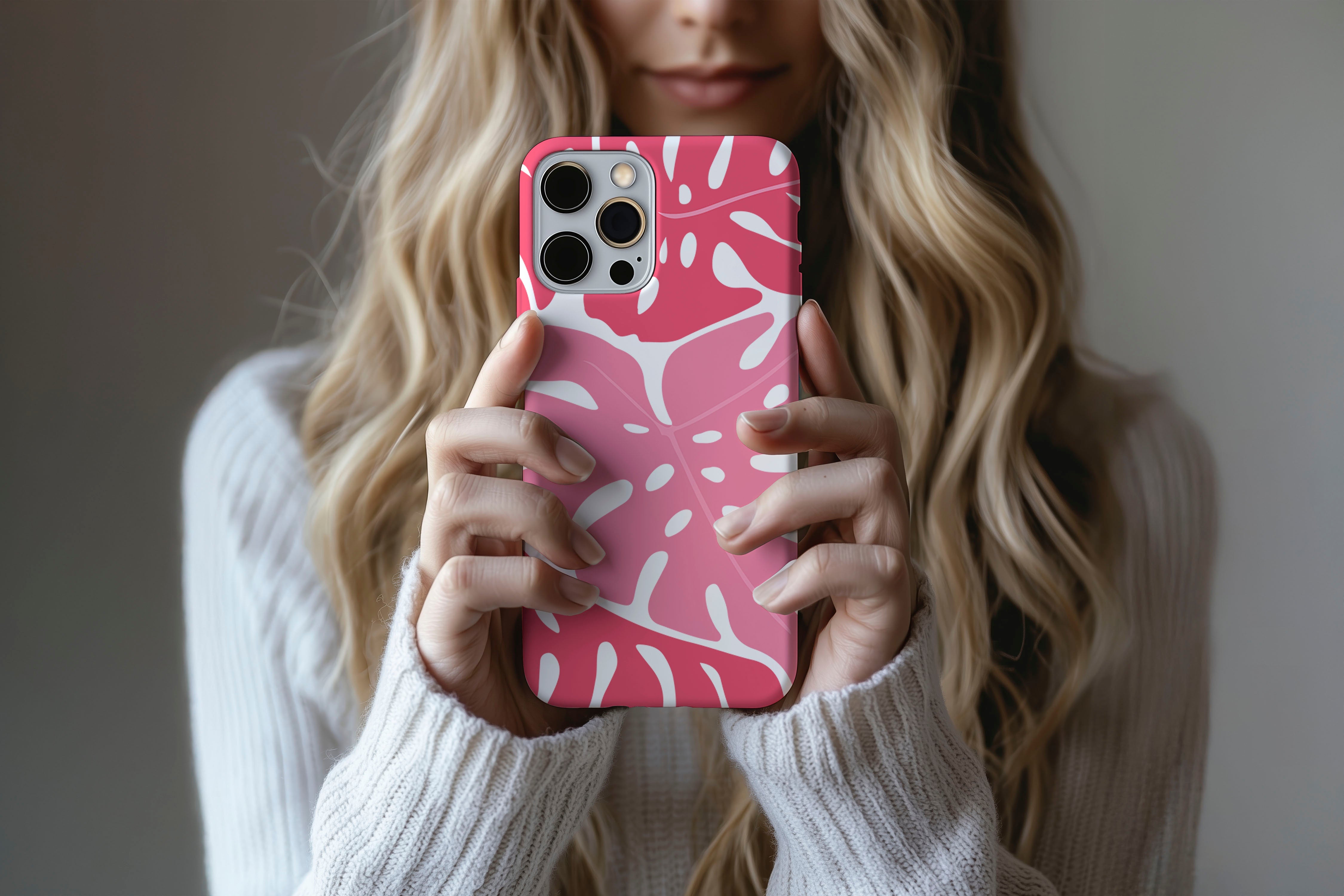 A cute girl holding a phone case featuring our Monstera design