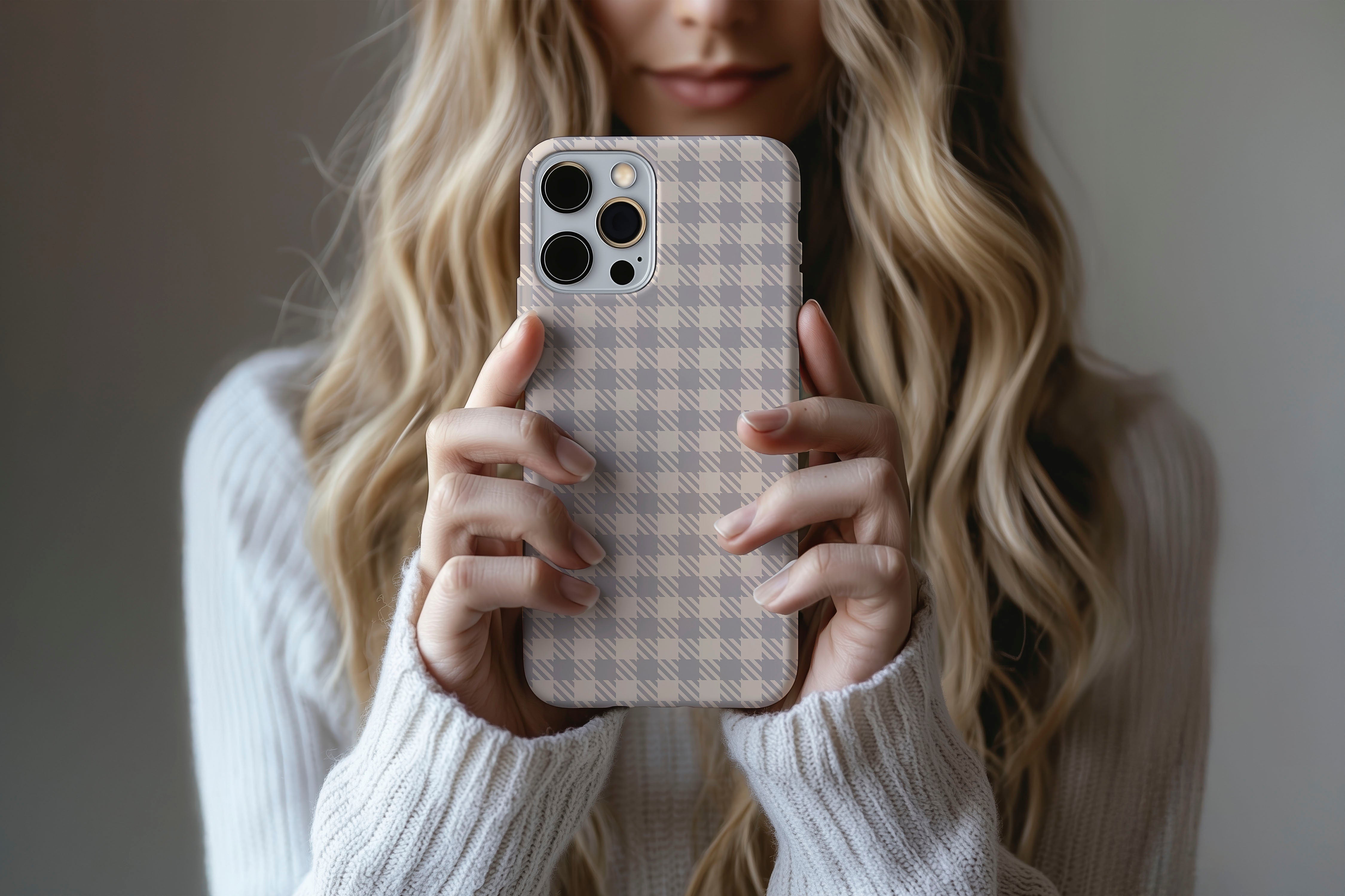 A cute girl holding a phone case featuring our Muted Houndstooth design