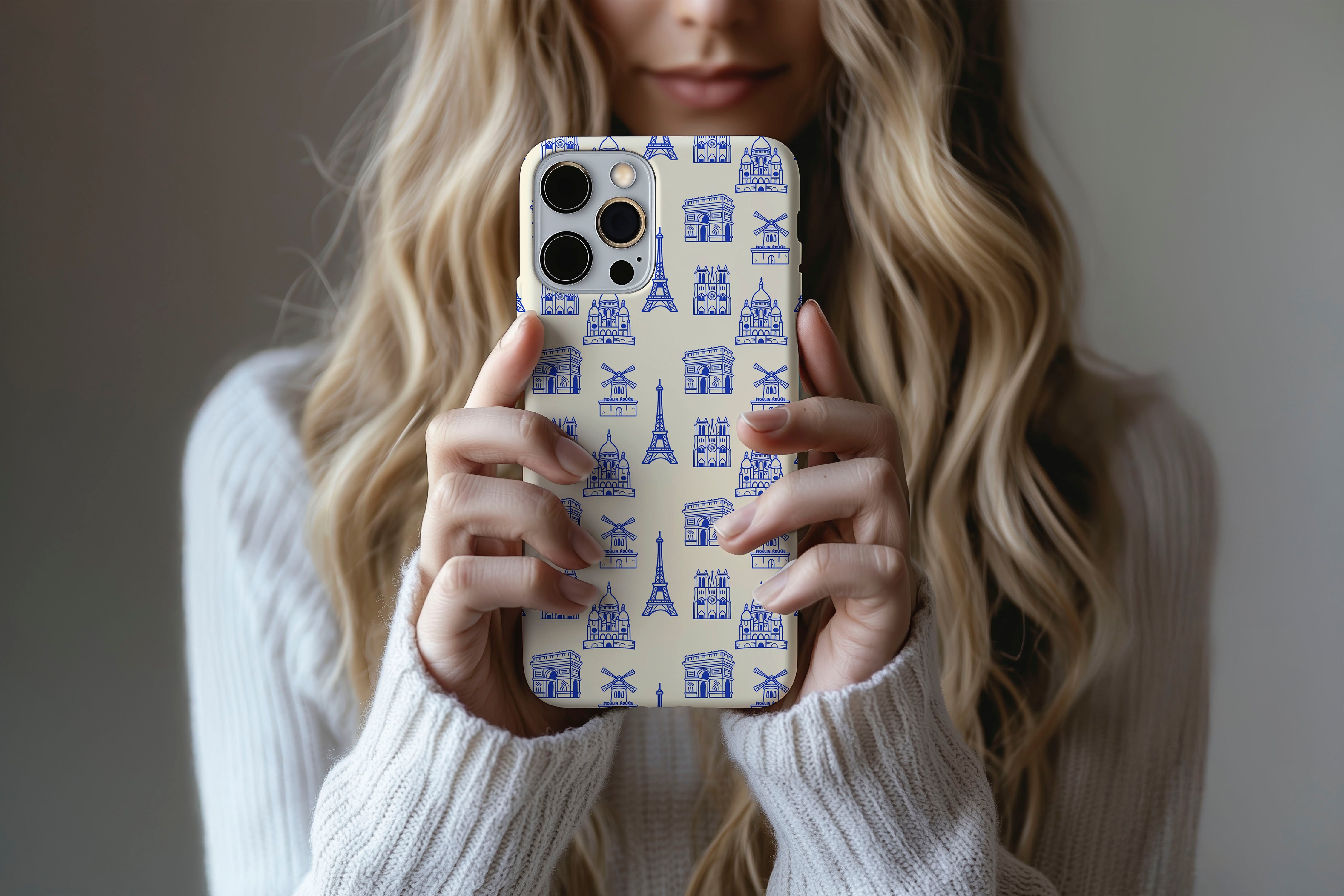 A cute girl holding a phone case featuring our Paris design