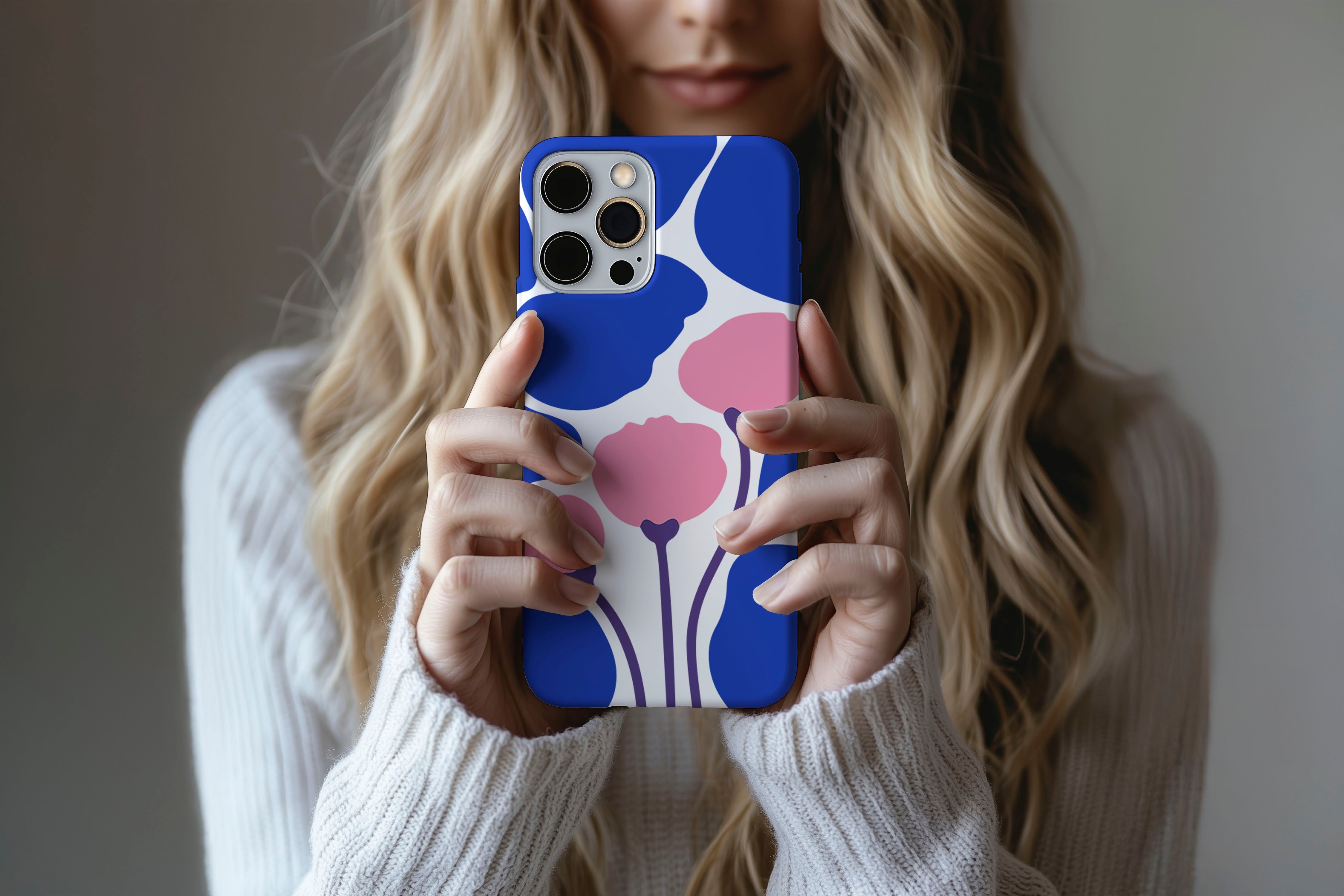A cute girl holding a phone case featuring our Poppy Art design