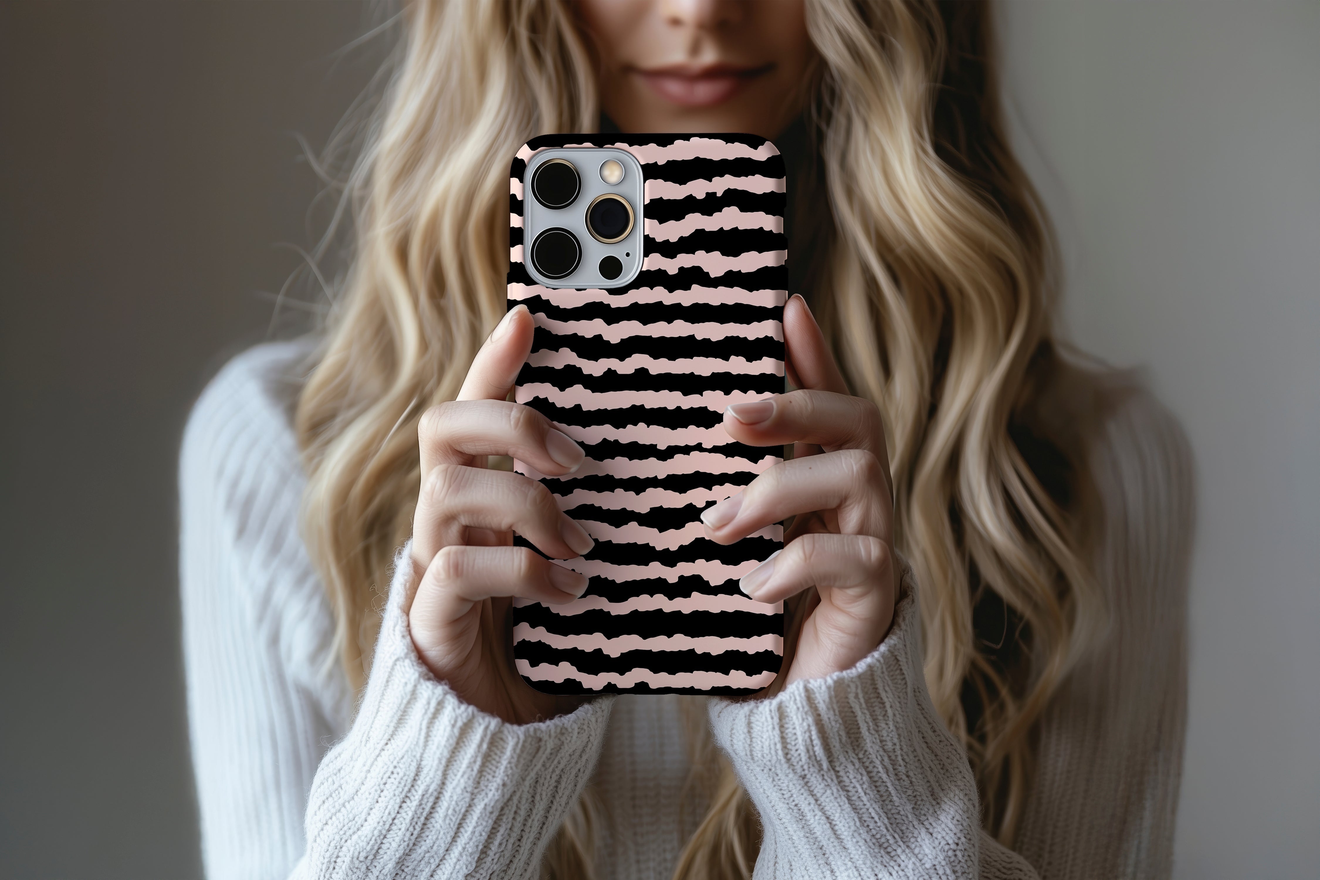 A cute girl holding a phone case featuring our Sound Wave  design