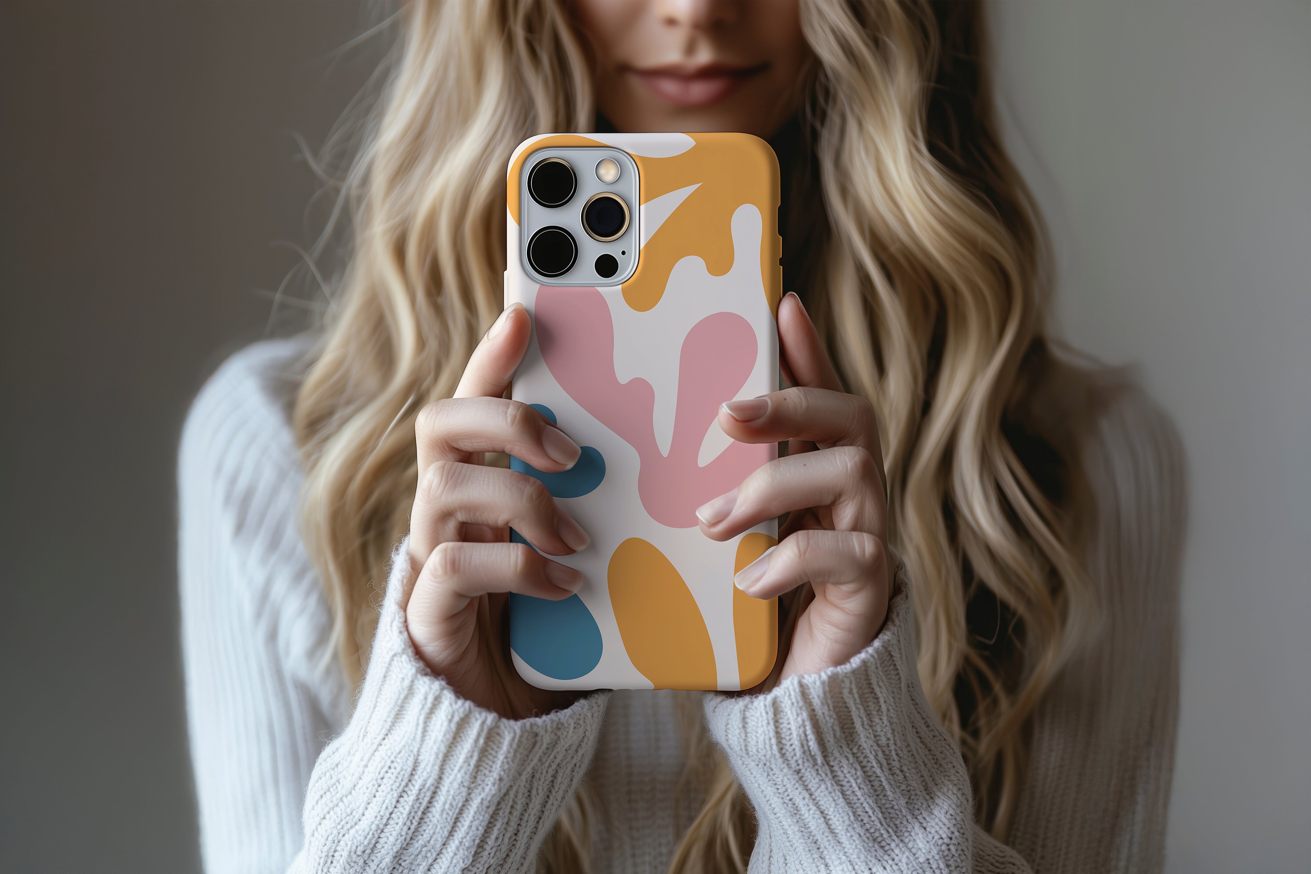 A cute girl holding a phone case featuring our Splash Of Colour  design