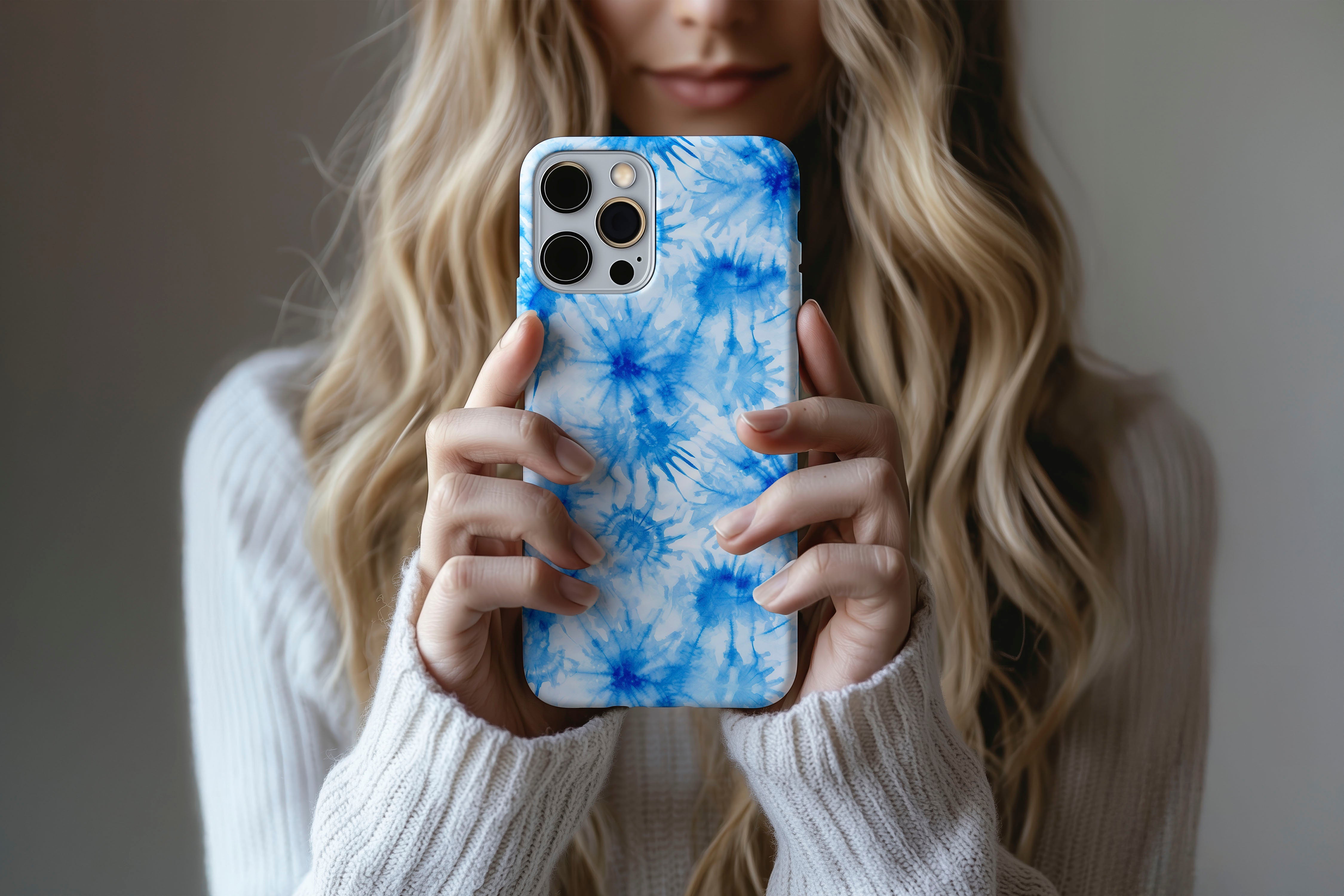 A cute girl holding a phone case featuring our Tie Dye Blue design